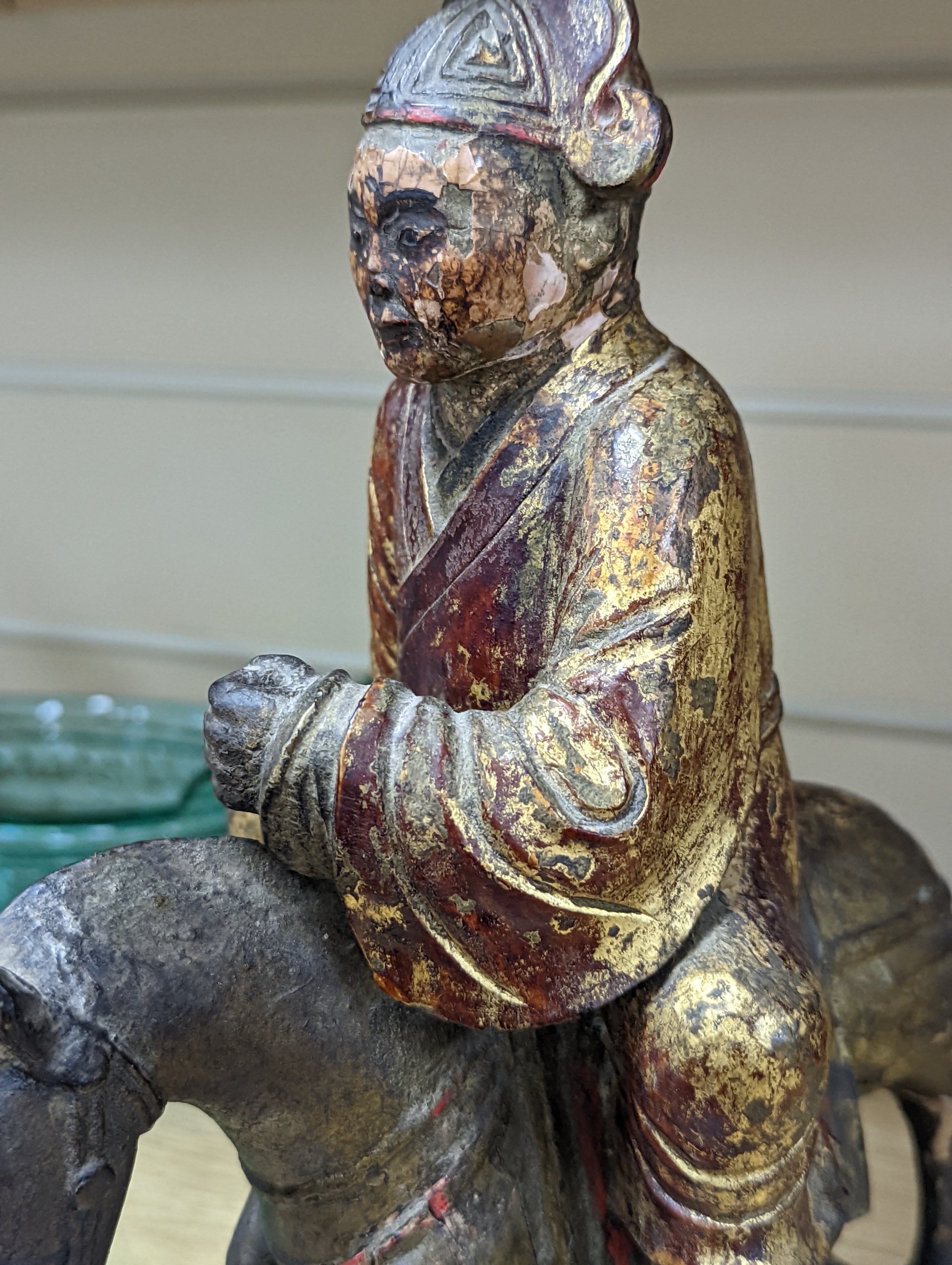 An 18th/19th century Chinese lacquered wood group of an official riding a horse, 30cm